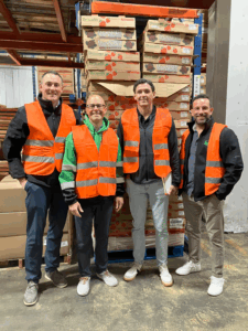 team members wearing safety vests in warehouse